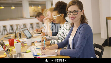 Smiling worker posing in office Stock Photo