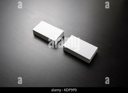 Blank white business cards on black wooden background. Mockup for branding identity. Template for graphic designers portfolios. Stock Photo