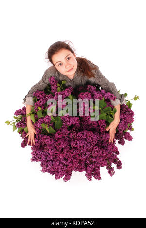 Attractive girl standing by the lilac. Isolated on a white background Stock Photo