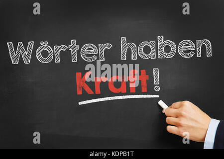 Wörter haben Kraft! (words have power) written with chalk on blackboard Stock Photo