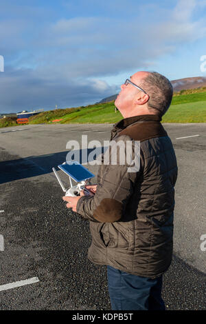 Middle age man, photographer flying a drone, County Kerry Ireland Stock Photo
