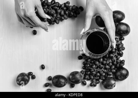 composition of wine, grape and plums Stock Photo