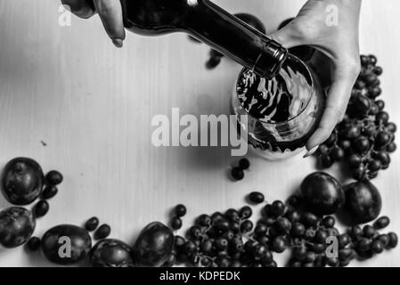 composition of wine, grape and plums Stock Photo