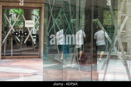 Hong Kong, China. 15th Oct, 2017. Glass of a building is strengthened with adhesive tapes in Hong Kong, south China, Oct. 15, 2017. China's national weather observatory on Sunday continued an orange alert for Typhoon Khanun, which is approaching the country's southern coast bringing rough gales and heavy storms. Credit: Wang Shen/Xinhua/Alamy Live News Stock Photo