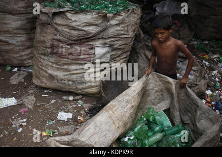 Dhaka, Bangladesh. 15th Oct, 2017. Siyam (10), a child labor sorts through polyethylene terephthalate (PET) bottles in a recycling factory at Kamrangichar. Recycling plastic bottles became a growing business for country where many child labor works for help family. Credit: Md. Mehedi Hasan/ZUMA Wire/Ģ����ý Live News Stock Photo