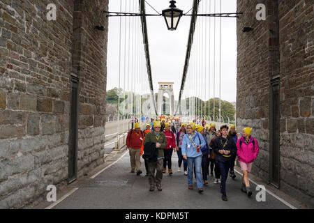 Bristol, United Kingdom, 15 October 2017.  Charity walkers cross the Clifton Suspension Bridge during the Countryfile Ramble, in aid of BBC Children In Need.  The bridge was closed to traffic at 11.30am for approximately 20 minutes to allow filming of the event.  Credit: mfimage/Alamy Live News Stock Photo