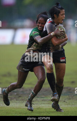 Colombo, Sri Lanka. 15th Oct, 2017. Player of Singapore is tackled by Player of  Sri Lanka  during the Asia Rugby Women's Sevens 2017 match between Sri Lanka and Singapore at Race Course Ground on 15 October 2017 in Colombo, Sri Lanka.  Credit: Lahiru Harshana/Alamy Live News