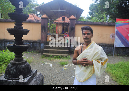 Valanjavattom, Kerala, India. 13th Oct, 2017. 13 Oct 2017 - Valanjavattom, Kerala - INDIA.Yedu Krishnan, 22, the first Dalit to be appointed as the Head priest, stands by the Manappuram Mahadev Temple .Kerala appoints its first Dalit Hindu priests.The south Indian state overturns centuries of discrimination against non-Brahmins.A small temple in Kerala witnessed a historic change last week when Yedu Krishnan took charge as its head priest - the first Dalit, or member of Hinduism's lowest castes, to be appointed to such a post in the state.For centuries, temple priests have be Stock Photo