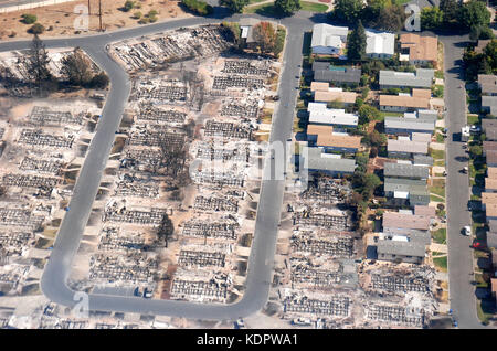The remains of a housing development after fires swept through the Coffey Park neighborhood destroying some homes but leaving others intact October 14, 2017 in Santa Rosa, California. Stock Photo
