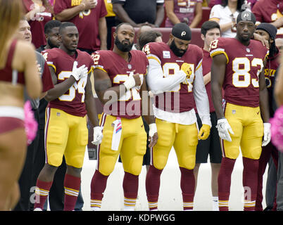 Landover, Maryland, USA. 15th Oct, 2017. Washington Redskins players stand at attention as the National Anthem is played prior to the game against the San Francisco 49ers at FedEx Field in Landover, Maryland on Sunday, October 15, 2017. From left to right: former center Jeff Bostic; running back Mack Brown (34); running back Samaje Perine (32); tight end Niles Paul (84) and wide receiver Brian Quick (83).Credit: Ron Sachs/CNP Credit: Ron Sachs/CNP/ZUMA Wire/Alamy Live News Stock Photo