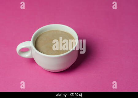 hot chocolate  in a ceramic cup on pink paper background Stock Photo