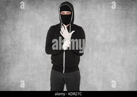 masked man wearing gloves Stock Photo