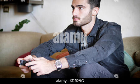 Young man using joystick or joypad for videogames Stock Photo