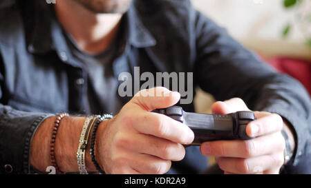 Young man using joystick or joypad for videogames Stock Photo