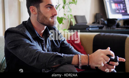 Young man using joystick or joypad for videogames Stock Photo