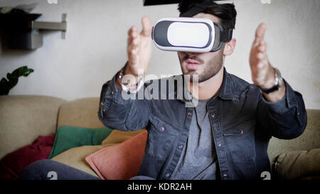 Young man using virtual reality viewer Stock Photo