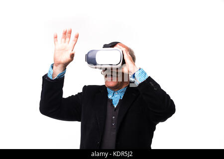 excited senior bearded man gesturing and using virtual reality headset Stock Photo