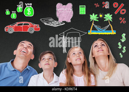 Happy Family Dreaming Of Having A Healthy Lifestyle On Blackboard Stock Photo