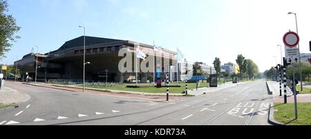 Panorama of the entrance to Delft Technical University campus, Netherlands. On left Aula Conference Centre, Brutalist architecture from the 1960s. Stock Photo