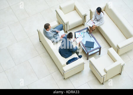 Discussing Joint Project with Colleagues Stock Photo