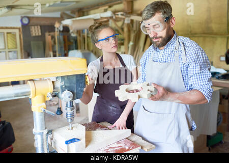Carpenters Making Wooden Parts in Workshop Stock Photo