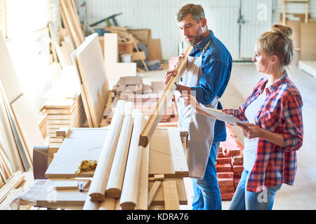 Modern Carpenters Choosing Wood Stock Photo