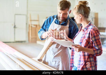 Modern Carpenters Choosing Wood in Joinery Stock Photo