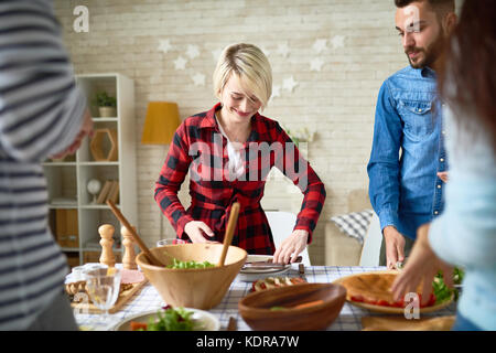 Young People Making Dinner Together Stock Photo