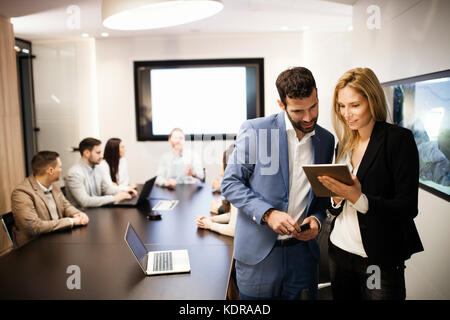 Portrait of attractive business partners using tablet Stock Photo