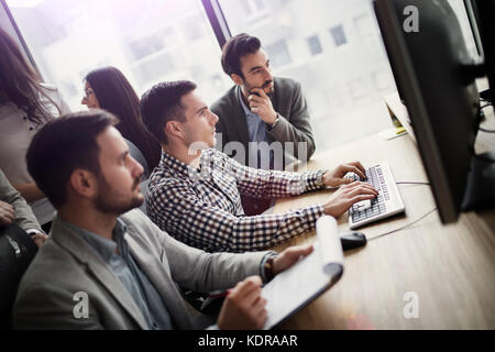 Portrait of group of business colleagues working on project Stock Photo