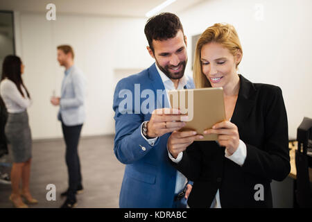 Portrait of attractive business partners using tablet Stock Photo
