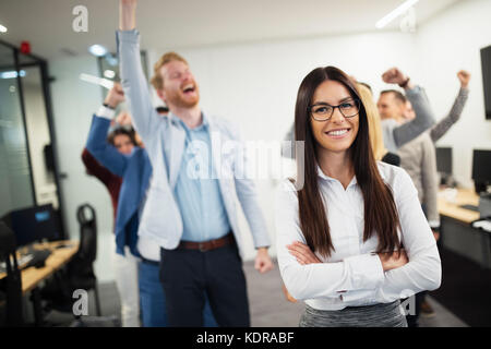 Business lady with positive look and cheerful smile posing for camera Stock Photo