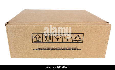 Basic simple closed cardboard shipping box with precautionary graphic symbols. Isolated. Stock Photo