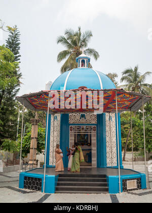 Woman by a colourful small chapel aside Santa Cruz Basilica, Kochi Stock Photo