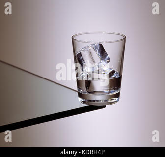 Still life. Glass tumbler of white spirit with ice. Stock Photo