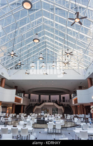 Dining area at Atlanta, Georgia's Colony Square under a glass ceiling of the sky-lit atrium revealing the modern W Atlanta-Midtown hotel tower. Stock Photo