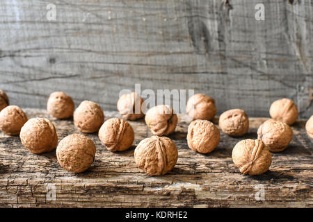 Delicious nuts and nutcrackers on an old wooden table, composition, copyspace Stock Photo