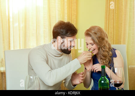 Man feeding woman grapes. Stock Photo