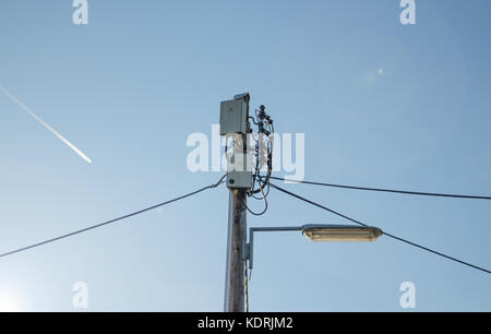 Electric cables wiring and public light on pole Stock Photo
