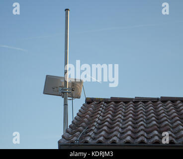 Small rectangle satellite and internet antenna on roof Stock Photo