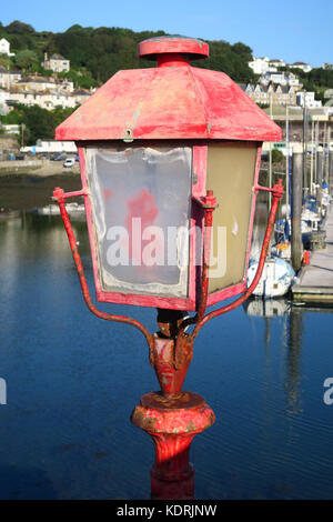 Fading light. An old  harbour light, Cornwall, England, UK. Standing noble but has seen better days. Stock Photo
