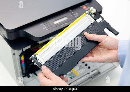 Man replacing toner in laser printer. toner printer cartridge print laser office supplies refill concept Stock Photo