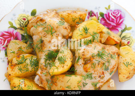 golden crispy skin chicken grilled in oven with potato wedges Stock Photo