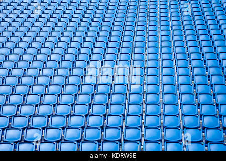 Folded blue plastic chairs on a temporary  tribune Stock Photo