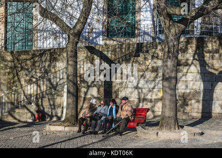 Portuguese people on a bench on a small square in Porto city, second largest city in Portugal Stock Photo