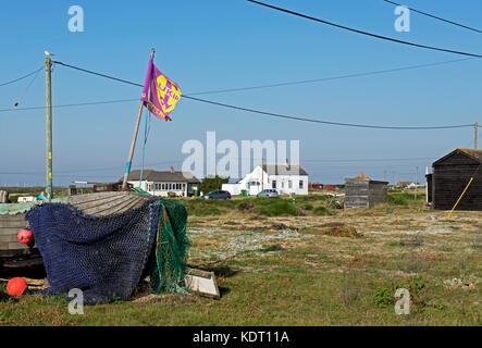UKIP flag flying next to shack on the shingle at Dungeness, Kent, England UK