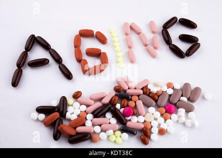 Hand writing text caption inspiration Medical care concept written with pills drugs capsule word aging ages On white isolated background with space Stock Photo