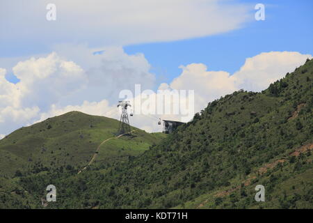 Ngong Ping 360 cable car tower with the cloudy landscape from Lantau Island in beautiful summer landscape Stock Photo