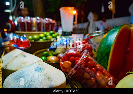 Ingredients for smoothie on street vendor's table at night. Stock Photo