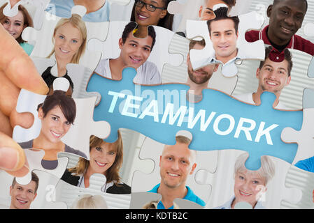 Teamwork Concept With Multicultural Business People Team On Jigsaw Puzzle Stock Photo